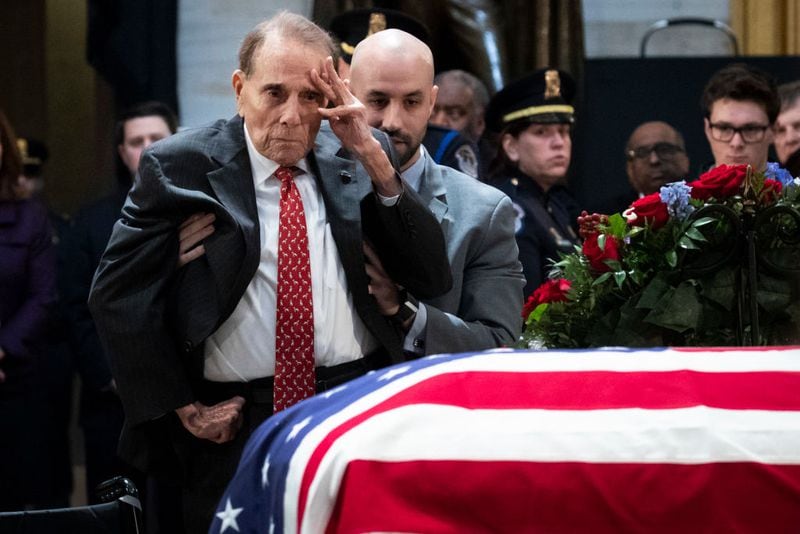 Former Senator Bob Dole stands up and salutes the casket of the late former President George H.W. Bush as he lies in state at the U.S. Capitol, December 4, 2018 in Washington, DC. A WWII combat veteran, Bush served as a member of Congress from Texas, ambassador to the United Nations, director of the CIA, vice president and 41st president of the United States. Bush will lie in state in the U.S. Capitol Rotunda until Wednesday morning.