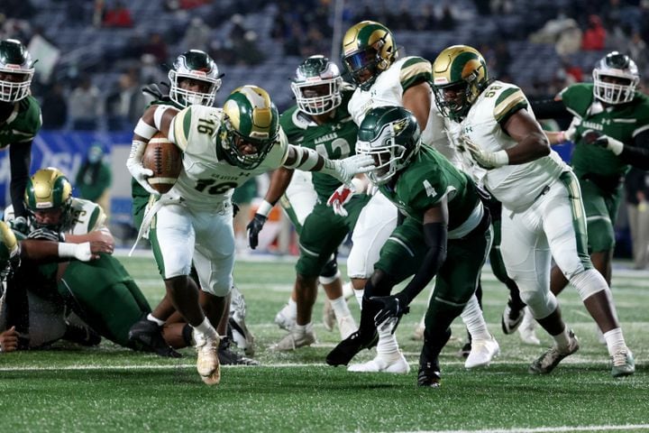 Dec. 30, 2020 - Atlanta, Ga: Grayson running back Jayvian Allen (16) scores a rushing touchdown against Collins Hill defensive back Justin Richardson (4) in the first half during the Class 7A state high school football final at Center Parc Stadium Wednesday, December 30, 2020 in Atlanta. JASON GETZ FOR THE ATLANTA JOURNAL-CONSTITUTION