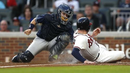 Freddie Freeman is tagged out by Padres catcher Raffy Lopez in the third inning of Friday's game at SunTrust Park. (Photo by Mike Zarrilli/Getty Images)