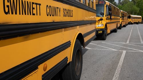 Gwinnett County buses line up in front of Berkmar High School in Lilburn on Tuesday morning April 7, while waiting to deliver lunches to students in the district. Ben@BenGray.com for the Atlanta Journal-Constitution