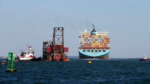 FILE- In this Sept. 14, 2015, file photo, the container ship Maersk Karlskrona, right, sails up river past the 300-foot dredge Alaska as it deepens the shipping channel to the port of Savannah off the coast of Tybee Island, Ga. The U.S. Army Corps of Engineers issued an Oct. 21, 2016 public notice announcing it was beginning permitting studies on the massive $4.5 billion container ship terminal on the Savannah River to be jointly built by Georgia and South Carolina. (AP Photo/Stephen B. Morton, File)