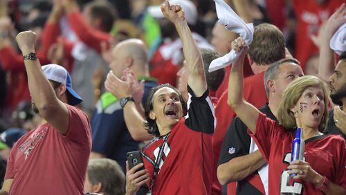 Falcons fans celebrate in the second half of the team’s playoff win over Seattle at the Georgia Dome. HYOSUB SHIN / HSHIN@AJC.COM