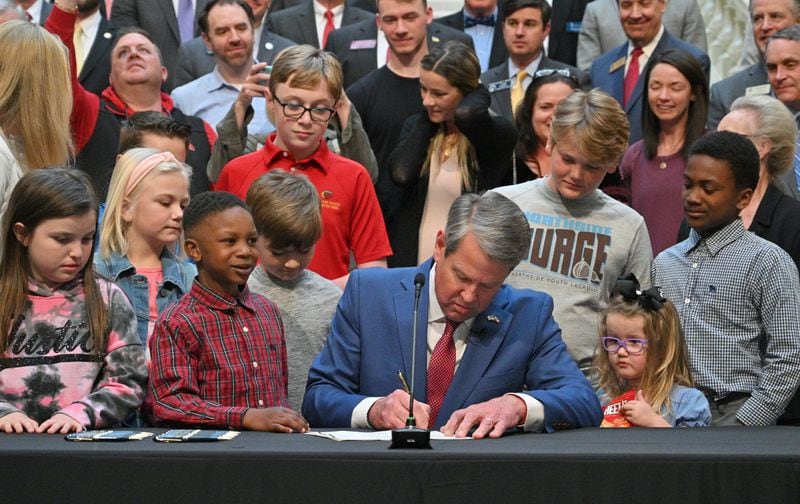 Gov. Brian Kemp signs legislation that allows parents who don’t want their children wearing masks to opt out of any school district mandates at the Georgia State Capitol on Tuesday, March 29, 2022. (Hyosub Shin / Hyosub.Shin@ajc.com)