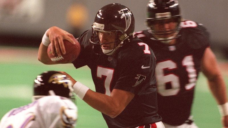 Falcons quarterback Tony Graziani makes his way around the Ravens' Rod Woodson during the first half Aug. 21, 1999, at the Georgia Dome in Atlanta. (David Tulis/AJC)