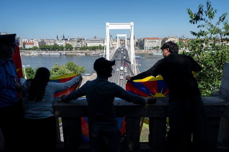 Tibetan protesters stretched a Tibetan flag in Gellert Hill against Chinese President Xi Jinping's visit to Budapest, Hungary on Thursday, May 9, 2024. (AP Photo/Denes Erdos)