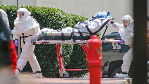 August, 5, 2014 Atlanta: Medical workers roll patient, Nancy Writebol into Emory University Hospital. The second American aid worker infected with Ebola arrived Tuesday, Aug. 5, 2014 in Atlanta. Nancy Writebol arrived in a chartered jet at Dobbins Air Reserve Base and was then taken in an ambulance to Emory University Hospital. She was taken from the ambulance by gurney and rolled into the hospital by suited medical personnel. Three days earlier, Dr. Kent Brantly, also diagnosed with the virus, arrived at Emory walked from the ambulance. The two patients are being treated in an isolation unit. MANDATORY CREDIT / JOHN SPINK/JSPINK@AJC.COM Medical workers roll patient, Nancy Writebol into Emory University Hospital. The second American aid worker infected with Ebola arrived Aug. 5 and was released after she was pronounced cured. John Spink, jspink@ajc.com