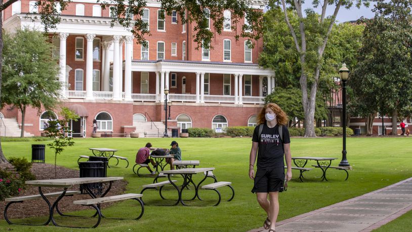 08/21/2020 - Milledgeville, Georgia - A Georgia College and State University student wears a face mask while traveling though the campus in Milledgeville, Friday, August 21, 2020.  (ALYSSA POINTER / ALYSSA.POINTER@AJC.COM)
