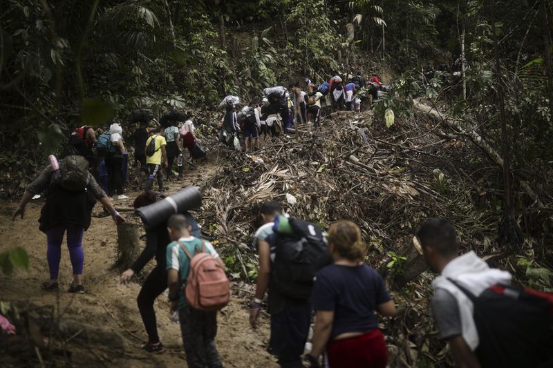 Migrants walk across the Darien Gap from Colombia to Panama in hopes of reaching the U.S., Tuesday, May 9, 2023. The image was part of a series by Associated Press photographers Ivan Valencia, Eduardo Verdugo, Felix Marquez, Marco Ugarte Fernando Llano, Eric Gay, Gregory Bull and Christian Chavez that won the 2024 Pulitzer Prize for feature photography. (AP Photo/Ivan Valencia)