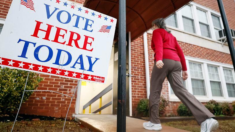 A person enters the Israel Baptist Church in Kirkwood during election day on Tuesday. Miguel Martinez / miguel.martinezjimenez@ajc.com