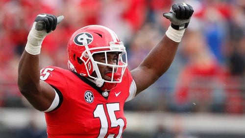 Georgia Bulldogs linebacker D'Andre Walker (15) celebrates after he tackled Florida Gators running back Lamical Perine (22) for no gain in the second half.  The University of Georgia Bulldogs beat the Florida Gators 36-17 in a NCAA college football game Saturday, Oct. 27th, 2018, at TIAA Bank Field in Jacksonville, FL.      BOB ANDRES / BANDRES@AJC.COM
