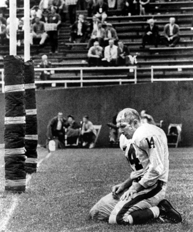 (Photo by Morris Berman. NY Giants quarterback Y.A. Tittle kneels in the endzone at Pitt Stadium after being sacked by Steelers defensive end John Baker in a 1964 game won by the Steelers 27-24. He retired from professional football the next year.  (Post-Gazette files/Photo by Morris Berman) Original Filename: Hist  y a tittle   Original Filename: Tittle.jpg