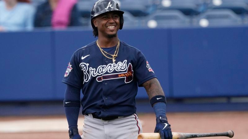 Atlanta Braves second baseman Ozzie Albies laughs with his teammates after driving a foul ball into the Braves dugout during the fourth inning against the Tampa Bay Rays Sunday, March 21, 2021, in Port Charlotte, Florida. (John Bazemore/AP)