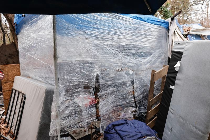 Views of Matthew Welch’s tent at an encampment near Buford Highway shown on Friday, December 29, 2023. Welch says he uses plastic wrap around his tent to shield himself from freezing temperatures. (Natrice Miller/ Natrice.miller@ajc.com)