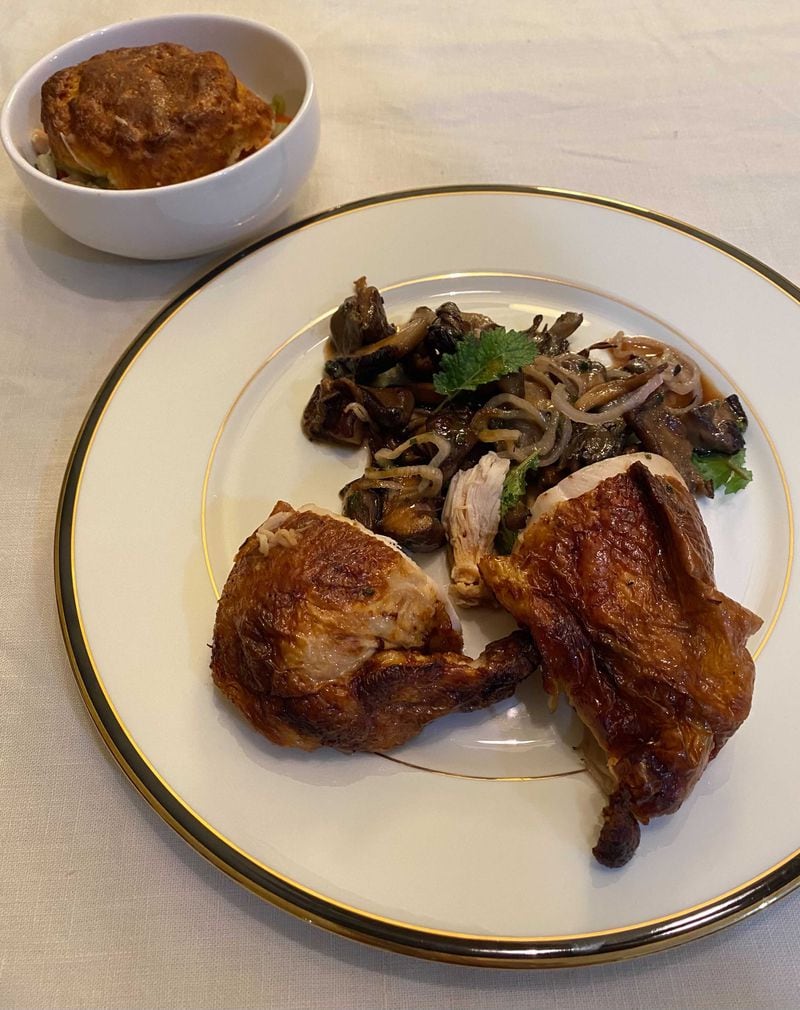 A filling order of roasted chicken breast from the Chastain comes with a warm mushroom salad and a bonus chicken pot pie, capped with a hot biscuit. Ligaya Figueras/ligaya.figueras@ajc.com
