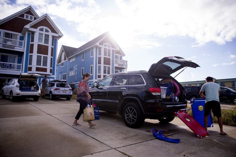 People pack up their cars to prepare to evacuate the Outer Banks area of North Carolina, on Tuesday, Sept. 11, 2018, ahead of Hurricane Florence. 