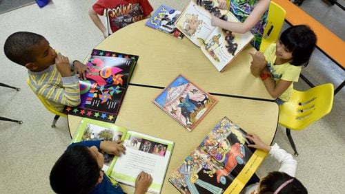 April 5, 2015 Lilburn, GA: Pre-K students at Sunshine House in Lilburn look at books during activities time. The Gwinnett County school district is researching ways to help parents and day care centers better prepare students for kindergarten. BRANT SANDERLIN/BSANDERLIN@AJC.COM