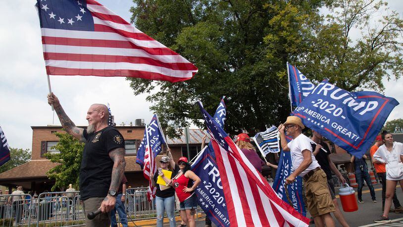 Chester Doles, the principal organizer of Saturday’s pro-Trump rally in Dahlonega, waves a flag at the beginning of the rally September 14, 2019. Republicans distanced themselves from the event that attracted white nationalists and supremacists. (Photo by STEVE SCHAEFER / SPECIAL TO THE AJC)