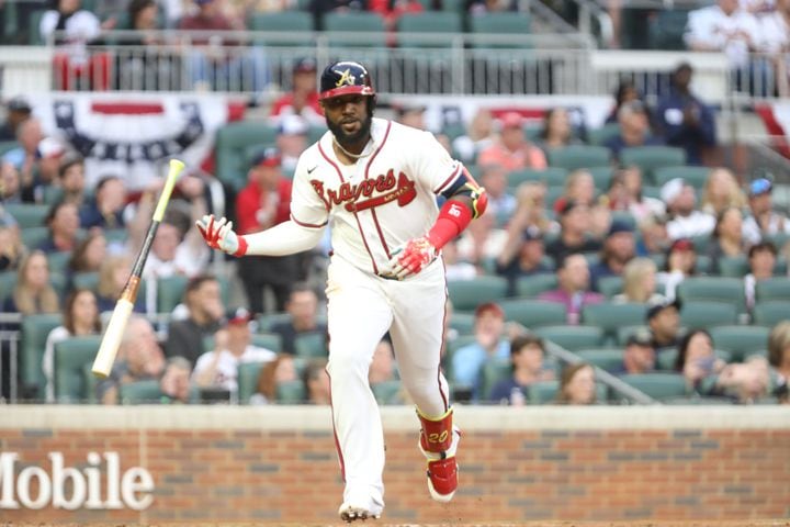 Braves left fielder Marcell Ozuna tosses his bat after driving in the team's first run during the first inning Monday night at Truist Park. (Miguel Martinez/miguel.martinezjimenez@ajc.com)