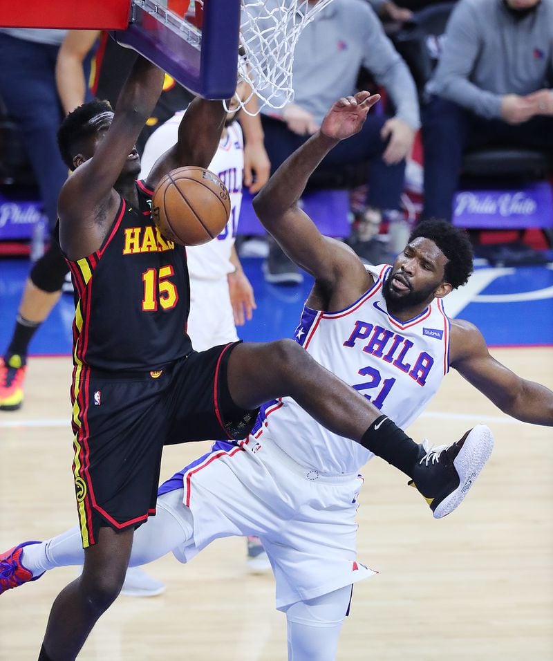 Hawks center Clint Capela dunks the ball over Philadelphia 76ers center Joel Embiid during the third quarter of Game 7 of the Eastern Conference semifinals Sunday, June 20, 2021, in Philadelphia. (Curtis Compton / Curtis.Compton@ajc.com)