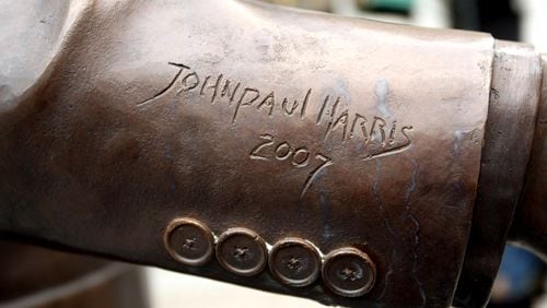 The bronze coat sleeve of the Andy Young statue is signed by the sculptor. John Spink/AJC