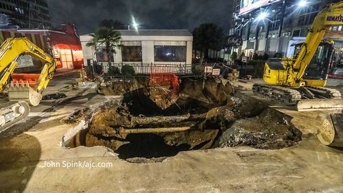 A large sinkhole opened up in front of Sufi’s Kitchen on Peachtree Street in Buckhead on Monday.