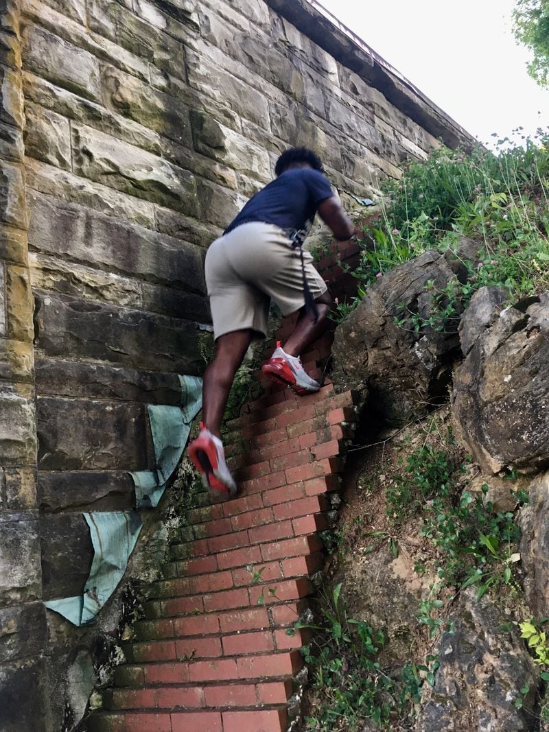 Georgia Tech freshman Jamious Griffin climbs up steps at Myrtle Hill Cemetery in Rome on May 14, 2019. Griffin said that the workouts at the cemetery were his least favorite of those that his father ran for him and his brothers. (AJC photo by Ken Sugiura)