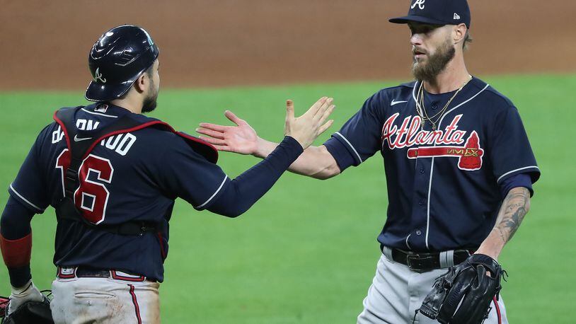 Atlanta Braves closing pitcher Shane Greene and catcher Travis d’Arnaud celebrate beating the Miami Marlins 7-0 in Game 3 of a National League Division Series for the sweep at Minute Maid Park on Thursday, Oct 8, 2020 in Houston.   “Curtis Compton / Curtis.Compton@ajc.com”