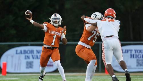 Kell quarterback Bryce Clavon (1) throws a long touchdown pass during the first half against Parkview in the 2023 Corky Kell + Dave Hunter Classic at Kell High School, Wednesday, August 16, 2023, in Marietta, Ga. (Jason Getz / Jason.Getz@ajc.com)