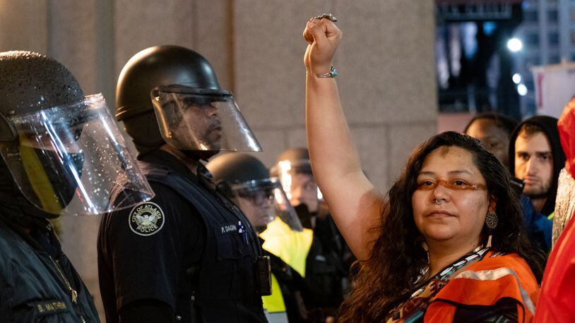 Siihasin Hope raises her arm in protest as Cop City protesters gather in Downtown Atlanta on Thursday, March 9, 2023.  Ben Gray for the Atlanta Journal-Constitution