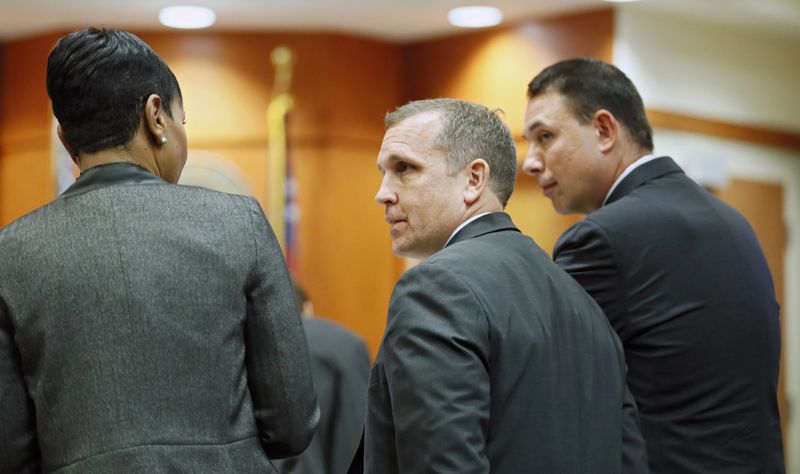 September 20, 2019 - Decatur - Prosecutors Buffy Thomas (from left), Pete Johnson and Lance Cross confer during the hearing.  Judge LaTisha Dear Jackson, the judge overseeing the murder trial against former DeKalb police officer Chip Olsen holds a pretrial hearing to consider the defense's request to keep out evidence that victim Anthony Hill was mentally ill and an Afghan war vet. Bob Andres / robert.andres@ajc.com