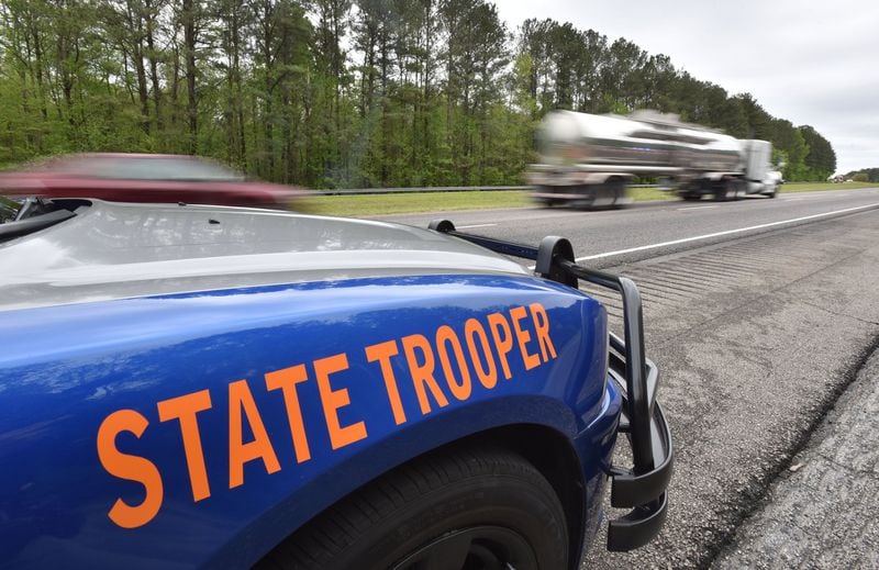 A State Patrol cruiser on duty on the interstate. Applications to the Patrol doubled in the week after the announcement of a major pay increase. HYOSUB SHIN / HSHIN@AJC.COM