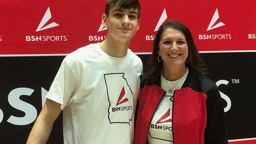 Wilson Sibley of North Oconee won the 2021 GHSA Slam Dunk Contest. He is with Carly Klingler, regional sales manager of BSN Sports, which sponsored the event.