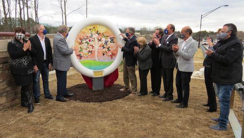Peachtree Corners' Mayor and City Council recently unveiled the city’s third Button Gwinnett sculpture adjacent to the pedestrian bridge. (Courtesy City of Peachtree Corners)