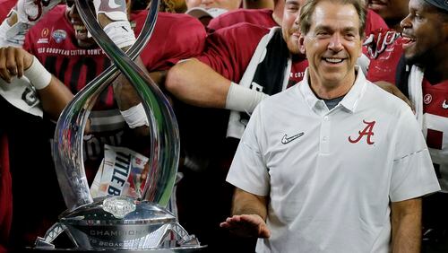 Alabama coach Nick Saban pauses next to the Field Scovell Trophy after his team's Cotton Bowl semifinal playoff game against Michigan State, Thursday night in Arlington, Texas. Alabama won 38-0 to advance to the national championship game. (AP photo)