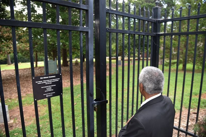Fred Smith, co-chair of Athens Area Black History Committee, looks toward Old Athens Cemetery near Baldwin Hall on University of Georgia campus. The discovery of 19th century African American remains in an area near the cemetery on UGA’s campus three years ago forced an examination of the history of slavery at the nation’s oldest land grant institution. HYOSUB SHIN / HSHIN@AJC.COM