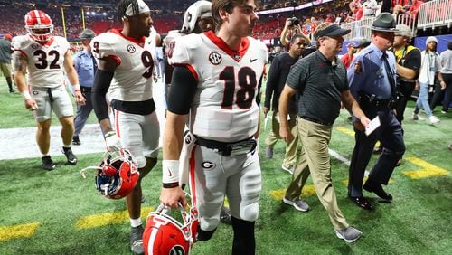 Georgia quarterback JT Daniels and head coach Kirby Smart walk off the field after the 41-24 loss to Alabama in the SEC championship game.