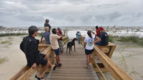 September 4, 2019 Tybee Island - Local residents and beachgoers who decided to stay watch the waves caused by Hurricane Dorian in Tybee Island on Wednesday, September 4, 2019. Gov. Brian Kemp on Wednesday expanded a state of emergency to include nine additional counties as Hurricane Dorianâs outer rain bands reached the Georgia coast. (Hyosub Shin / Hyosub.Shin@ajc.com)