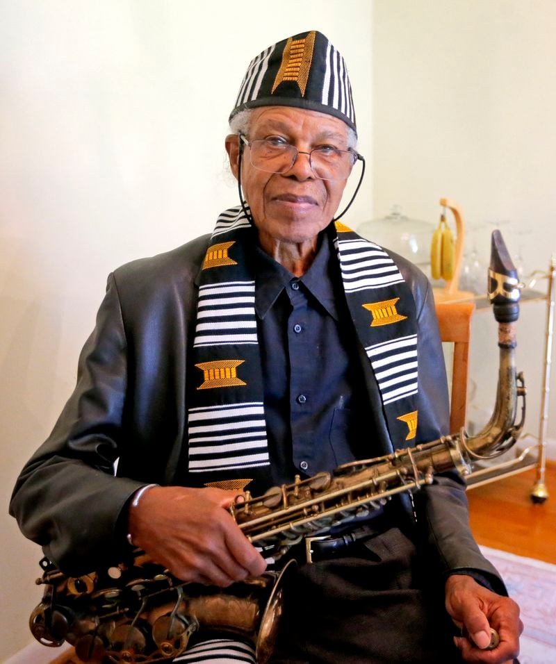 James Patterson holds the first saxophone he bought in his home in Atlanta on Friday, July 2, 2021. Patterson is a longtime jazz musician as well as an associate music professor at Clark Atlanta University. (Christine Tannous / christine.tannous@ajc.com)