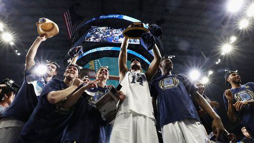 The Villanova Wildcats celebrate after defeating Michigan for the national championship Monday night in San Antonio.