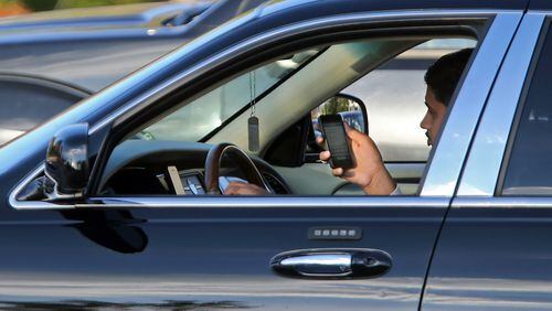 Georgia's new distracted driving law allows teenagers to use electronic devices while driving - as long as they use hands-free technology. JASON GETZ / JGETZ@AJC.COM