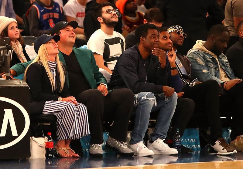 Masters Champion  Patrick Reed (2nd L), looks on with wife Justine, comedian Chris Rock, comedian Aziz Anzari and rapper 2 Chainz during the game between the New York Knicks and the Cleveland Cavaliers at Madison Square Garden on April 9, 2018 in New York City.