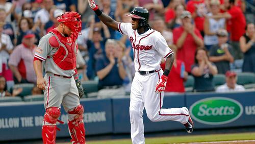 Cameron Maybin runs past Phillies catcher Cameron Rupp as he completes his home-run trot in a July 4 game. (AP Photo/John Bazemore)