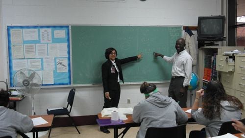 Victoria Jones,Sinclair women’s basketball coach and the site supervisor of the Sinclair education program at Dayton Correctional Institution. with math professor Kunle Akerele in a GED class at the prison (photo by Alan Mattingly/DCI) .
