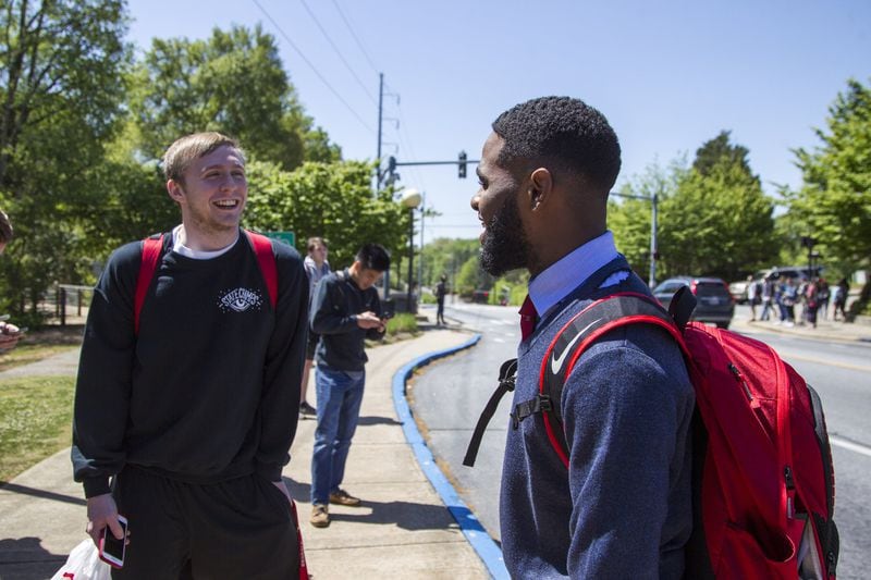 Destin Mizelle, right, a third year psychology student at the University of Georgia and newly elected SGA treasurer, talks with Cayman Bickerstaff, left, a third year cellular biology student at the University of Georgia, in between classes on the University of Georgia campus in Athens, Georgia, on Tuesday, April 17, 2018. (REANN HUBER/REANN.HUBER@AJC.COM)