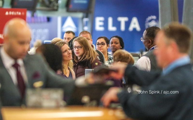 Delta agents work to resolve delays created by "a brief third-party technology issue" that impacted the airlines Monday morning.
