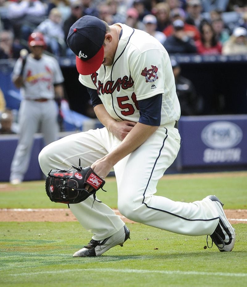 Braves reliever Dan Winkler collapses after breaking his right elbow throwing a pitch in an April 10 game against the Cardinals. Cardinals. (AP Photo/John Amis)