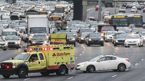 A crash and car fire shut down I-20 West just east of the Downtown Connector earlier this year. Insurers say they are increasing auto insurance premiums because accidents are on the rise. Photo credit: JOHN SPINK /JSPINK@AJC.COM