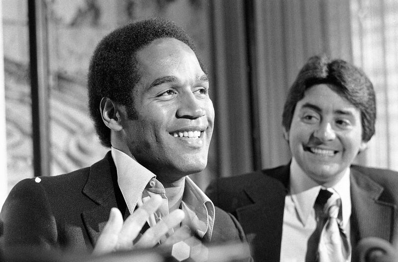 FILE - O.J. Simpson speaks to the media about being traded from the Buffalo Bills to the San Francisco 49ers as 49ers owner Edward DeBartolo Jr. looks on during a press conference in San Francisco, March 24, 1978. O.J. Simpson, the decorated football superstar and Hollywood actor who was acquitted of charges he killed his former wife and her friend but later found liable in a separate civil trial, has died. He was 76. Simpson's attorney confirmed to TMZ he died Wednesday night, April 10, 2024, in Las Vegas.(AP Photo/Sal Veder, File)