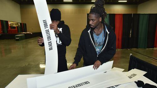 Derek Speight (left) and Desmond White prepare on Friday for the Black College Expo at Cobb Galleria Centre. The event, which will feature representatives of 100 schools, takes place on Saturday. HYOSUB SHIN / HSHIN@AJC.COM