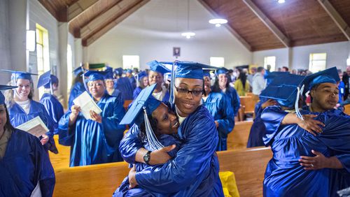 Veronica Fuller (center) hugs Ameshia Ervin (left) after graduating in April 2015 from the theological studies certficate program at the Lee Arrendale Correctional Facility in Alto. U.S. Rep. Doug Collins, R-Gainesville, is leading an effort that would help outgoing federal prisoners re-enter society by serving the final days of their sentences in halfway houses or home confinement if they complete programs such as vocational training, mental health or substance abuse counseling while behind bars. JONATHAN PHILLIPS / SPECIAL